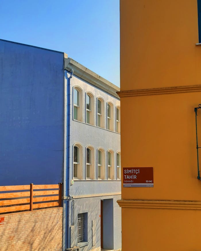 Home Vibrant blue and yellow townhouses in a sunny İstanbul street, Turkey.